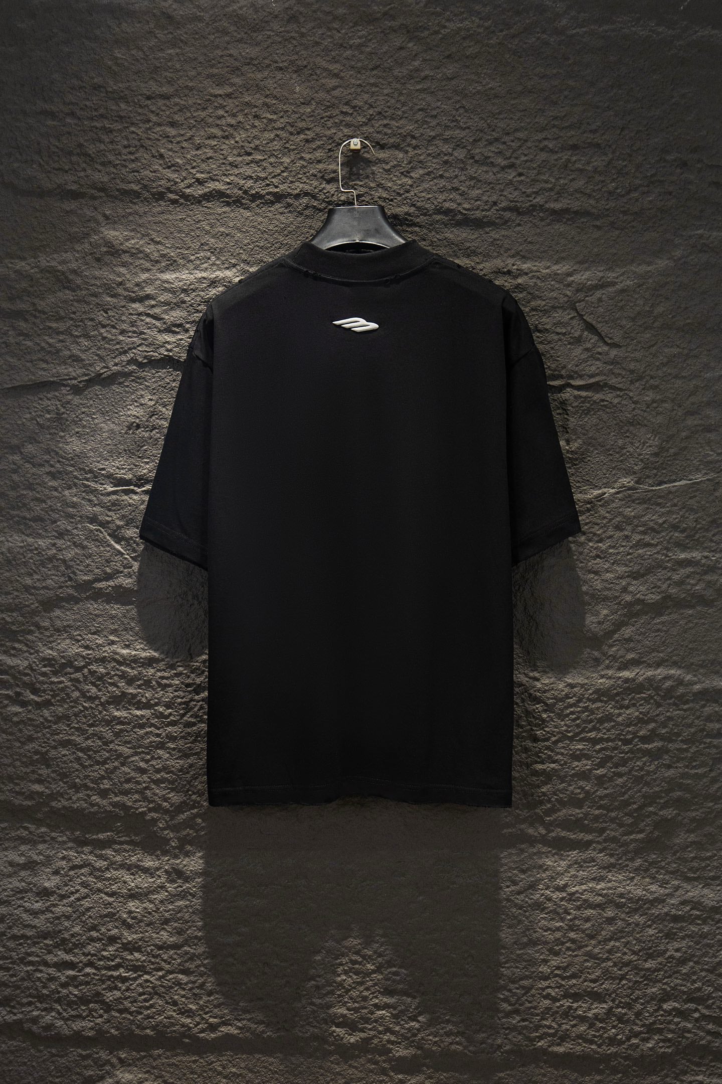 Black short-sleeve T-shirt with small chest logo on back.