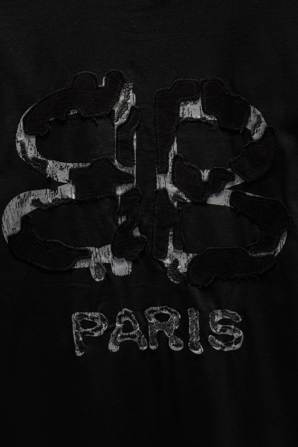Black short-sleeve T-shirt with PARIS text and abstract back graphic.