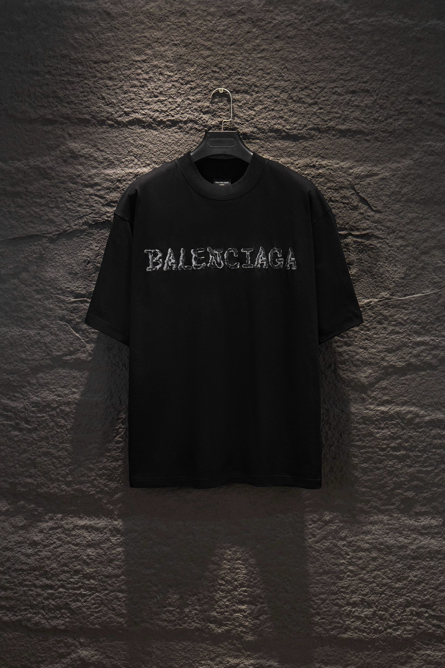 Black short-sleeve T-shirt with BALENCIAGA chest graphic.