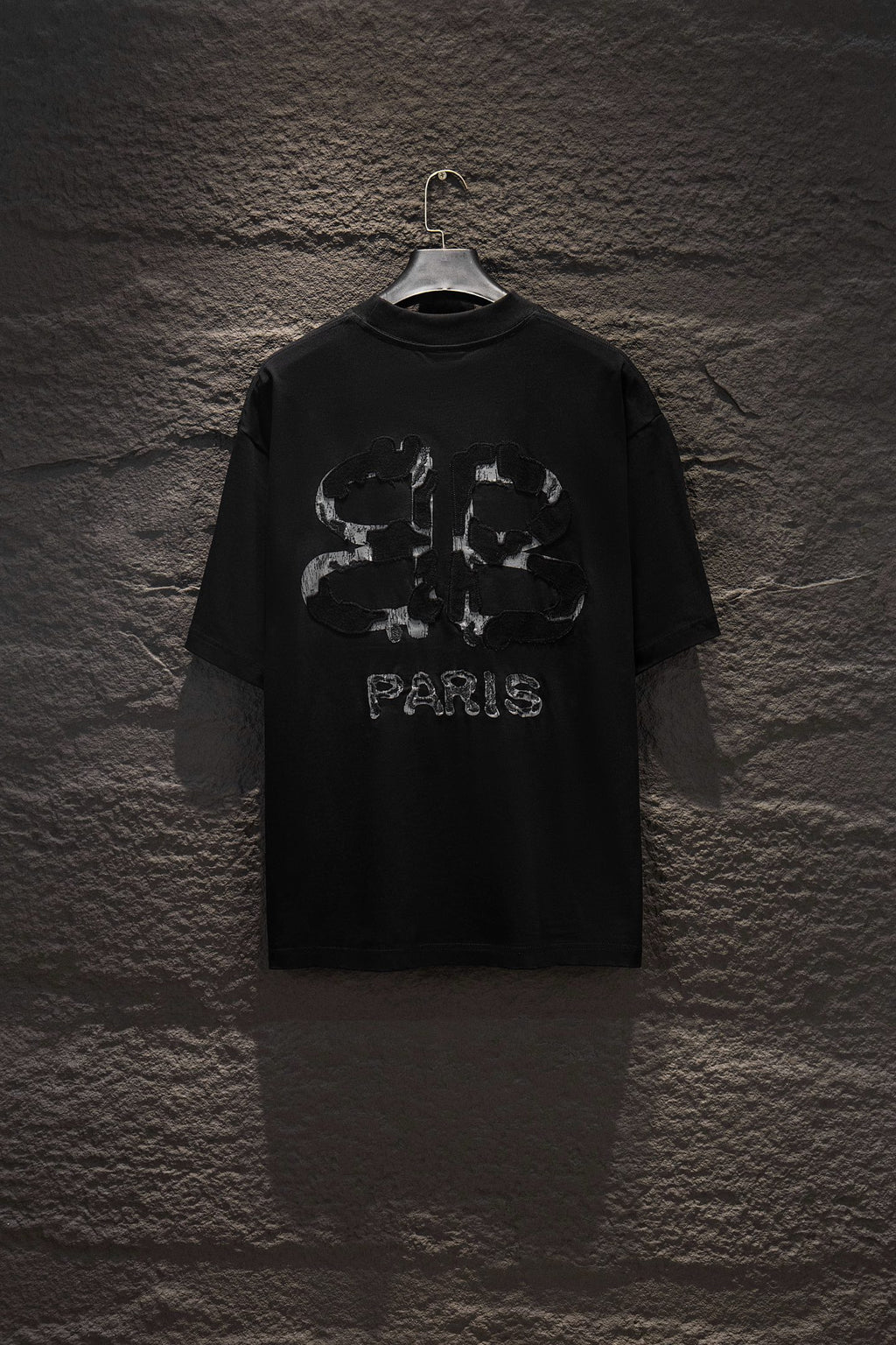 Black short-sleeve T-shirt with large PARIS back graphic.