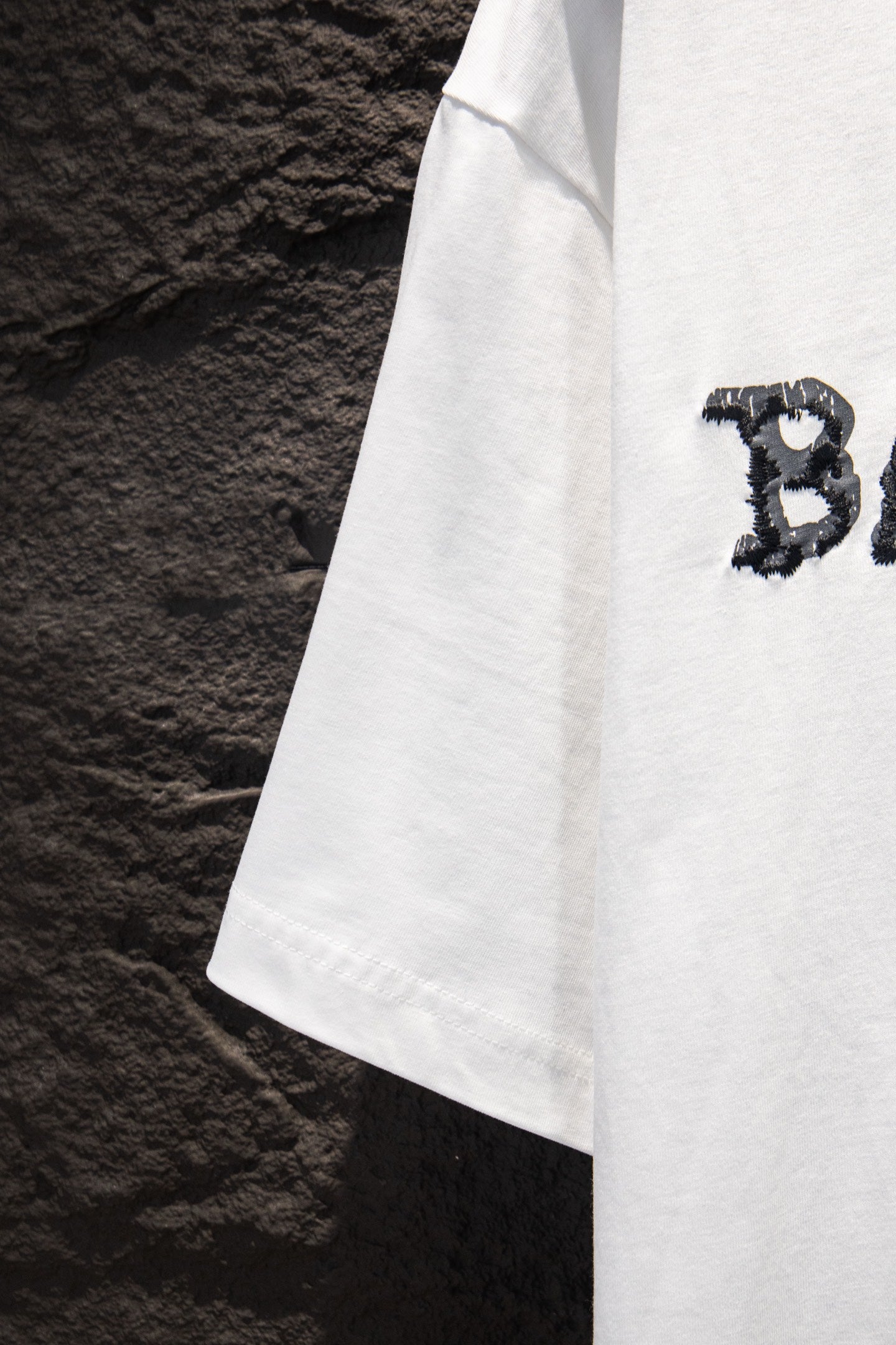Balenciaga white T-shirt side view with small CB graphic detail