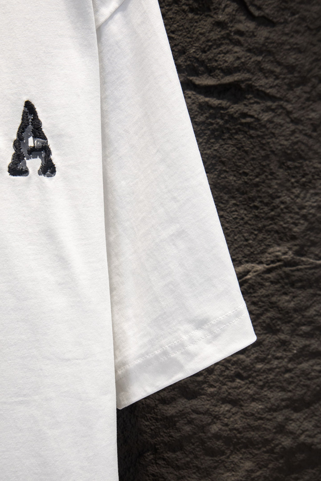 Balenciaga white T-shirt side view with partial graphic letter A