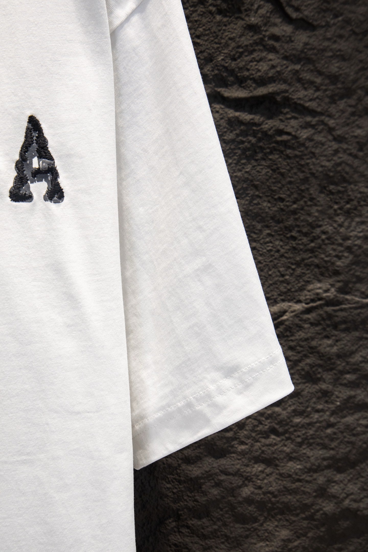 Balenciaga white T-shirt side view with partial graphic letter A