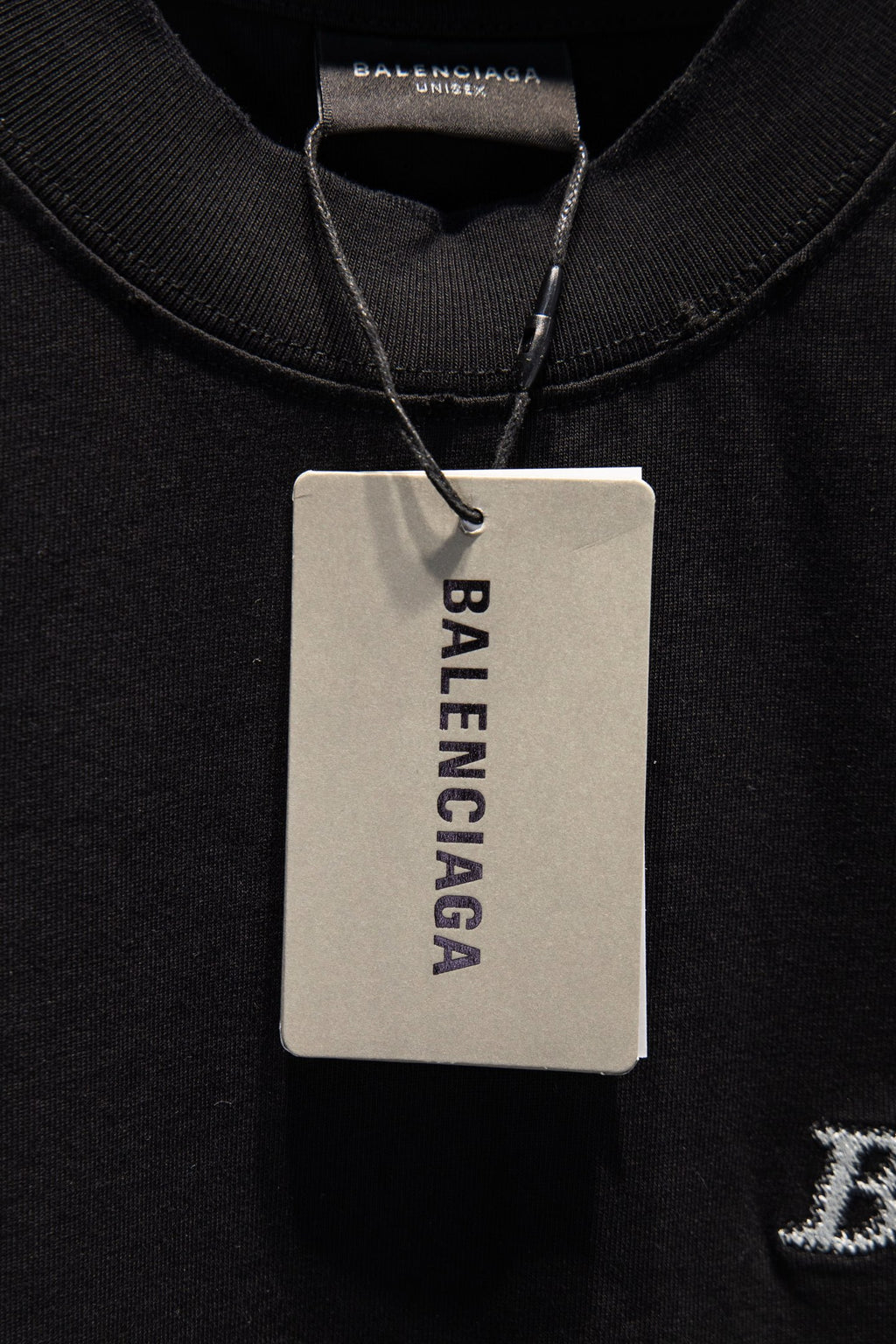 Balenciaga black T-shirt with hanging brand tag and ribbed crew neckline