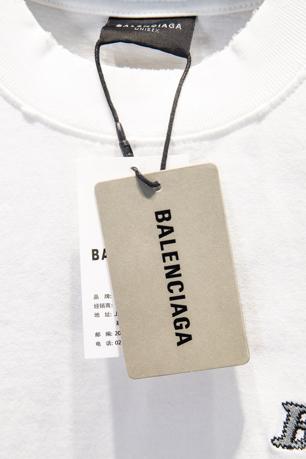 Balenciaga white T-shirt neckline with attached paper hang tag