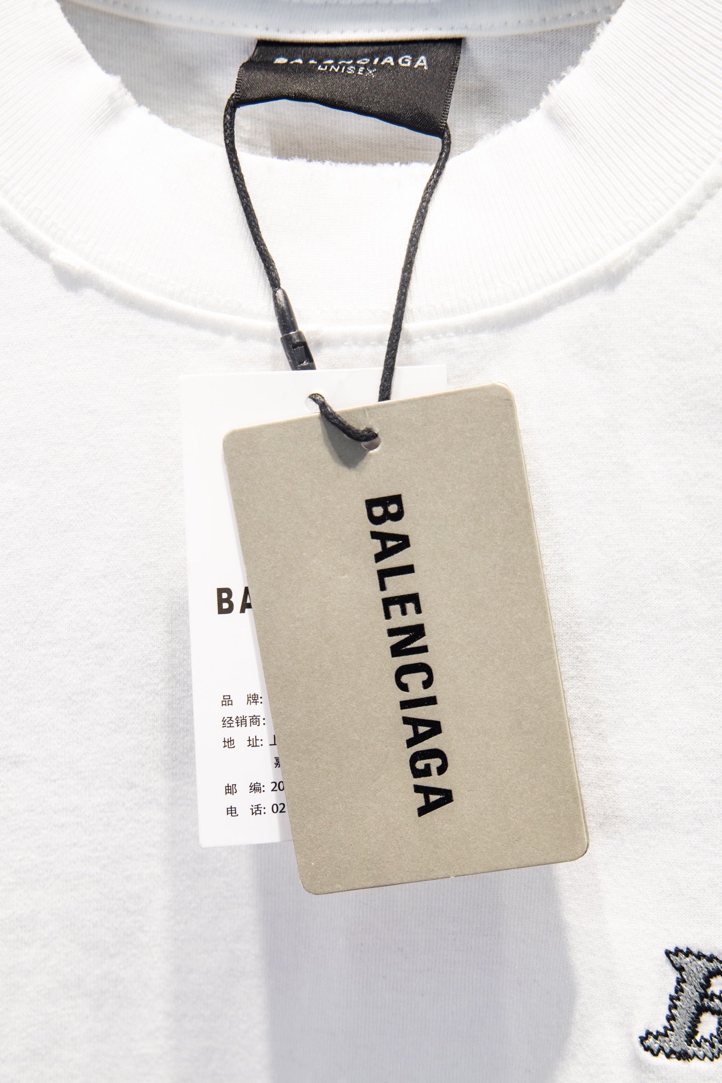 Balenciaga white T-shirt neckline with attached paper hang tag