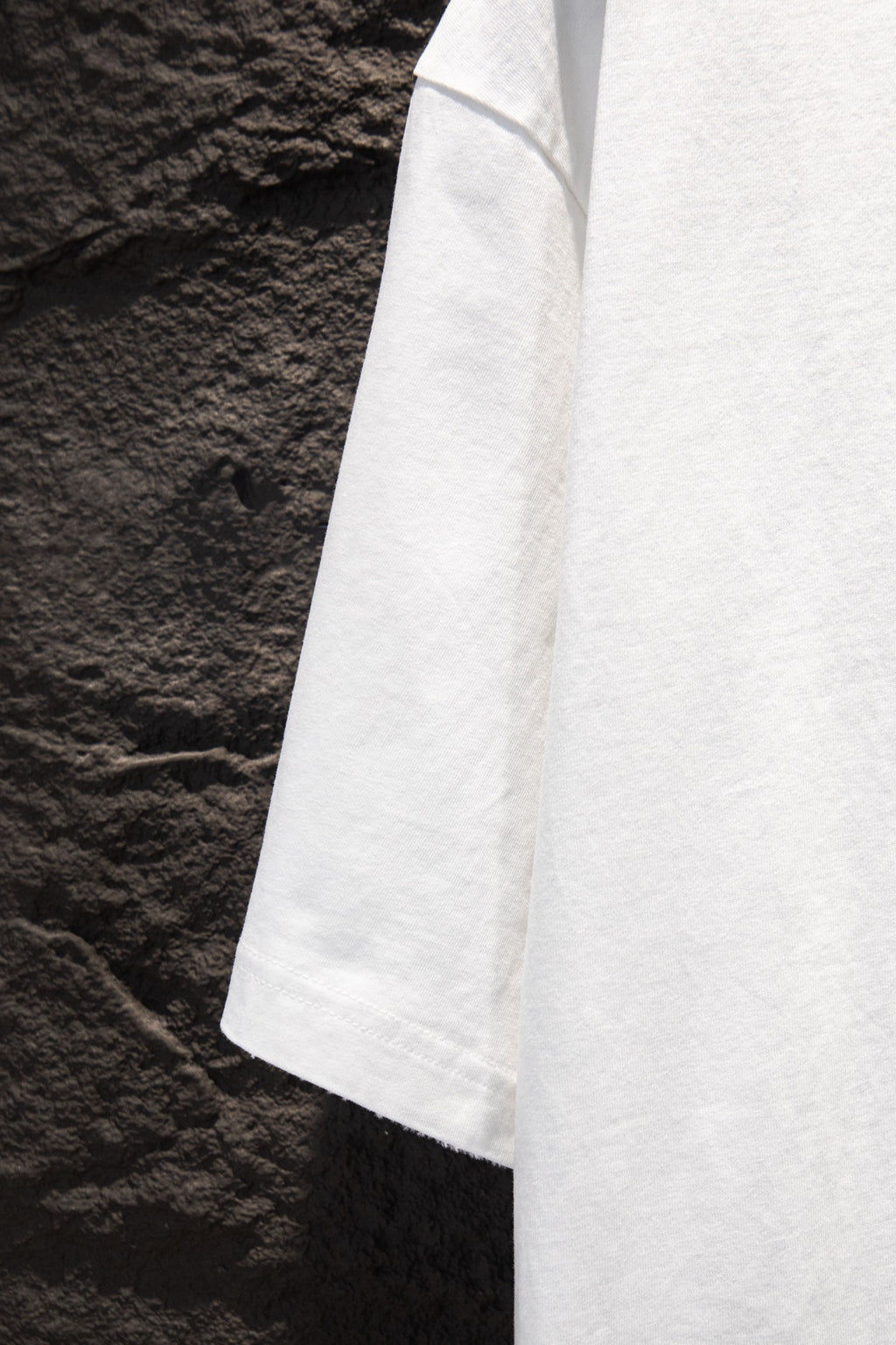 Balenciaga white short-sleeve T-shirt shown from side seam and hem