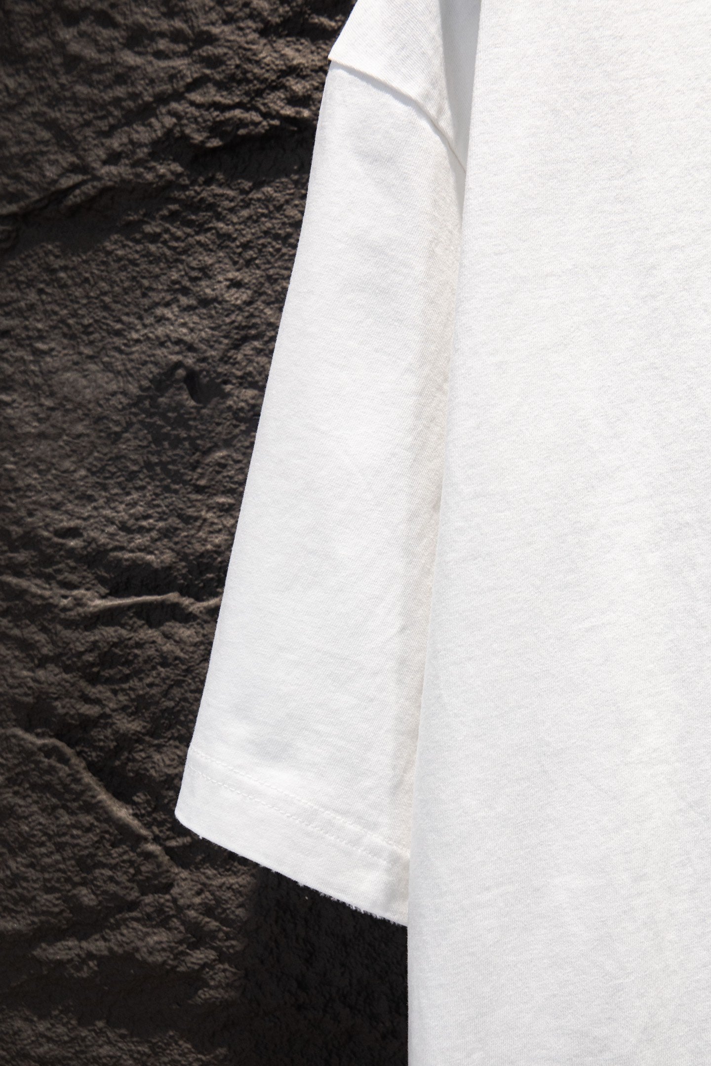 Balenciaga white short-sleeve T-shirt shown from side seam and hem
