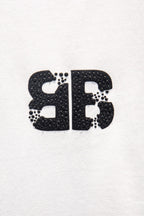 Balenciaga front logo patch on white T-shirt, black glitter-style print