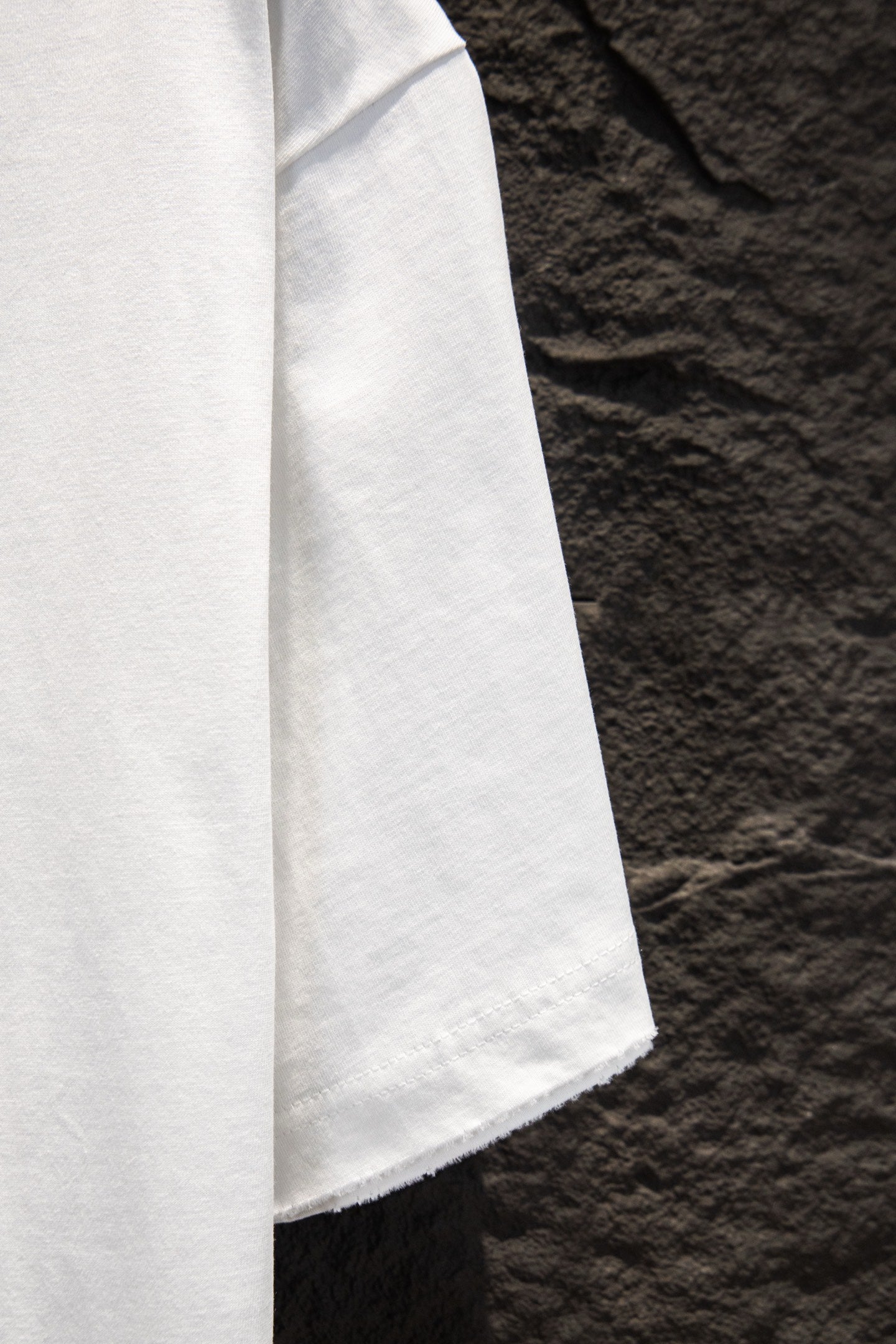 Balenciaga white T-shirt sleeve and shoulder seam, angled view
