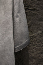 Light gray T-shirt side seam and curved lower hem