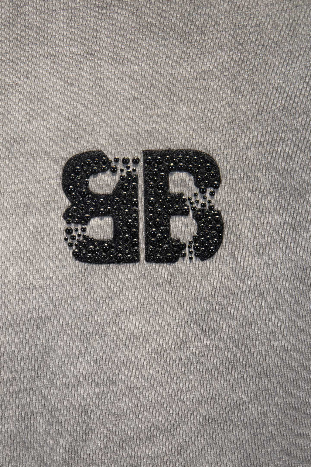 Black rhinestone-style BALENCIAGA letter graphic on light gray T-shirt
