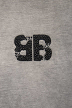 Black rhinestone-style BALENCIAGA letter graphic on light gray T-shirt