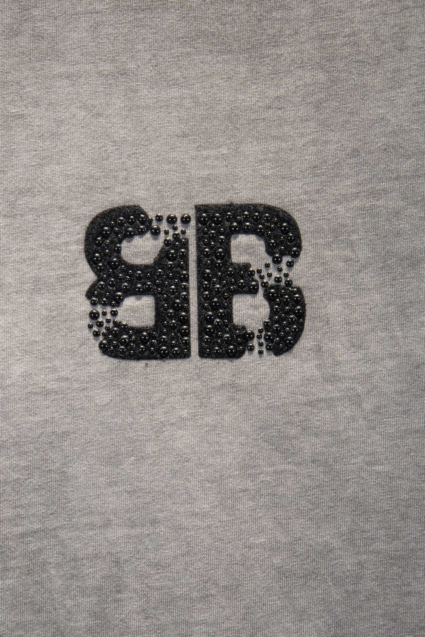 Black rhinestone-style BALENCIAGA letter graphic on light gray T-shirt