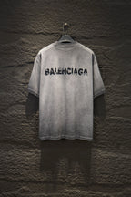 Light gray crewneck T-shirt with black BALENCIAGA logo on back
