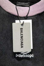 Balenciaga T-shirt with pink ribbed collar and hanging tag; black fabric