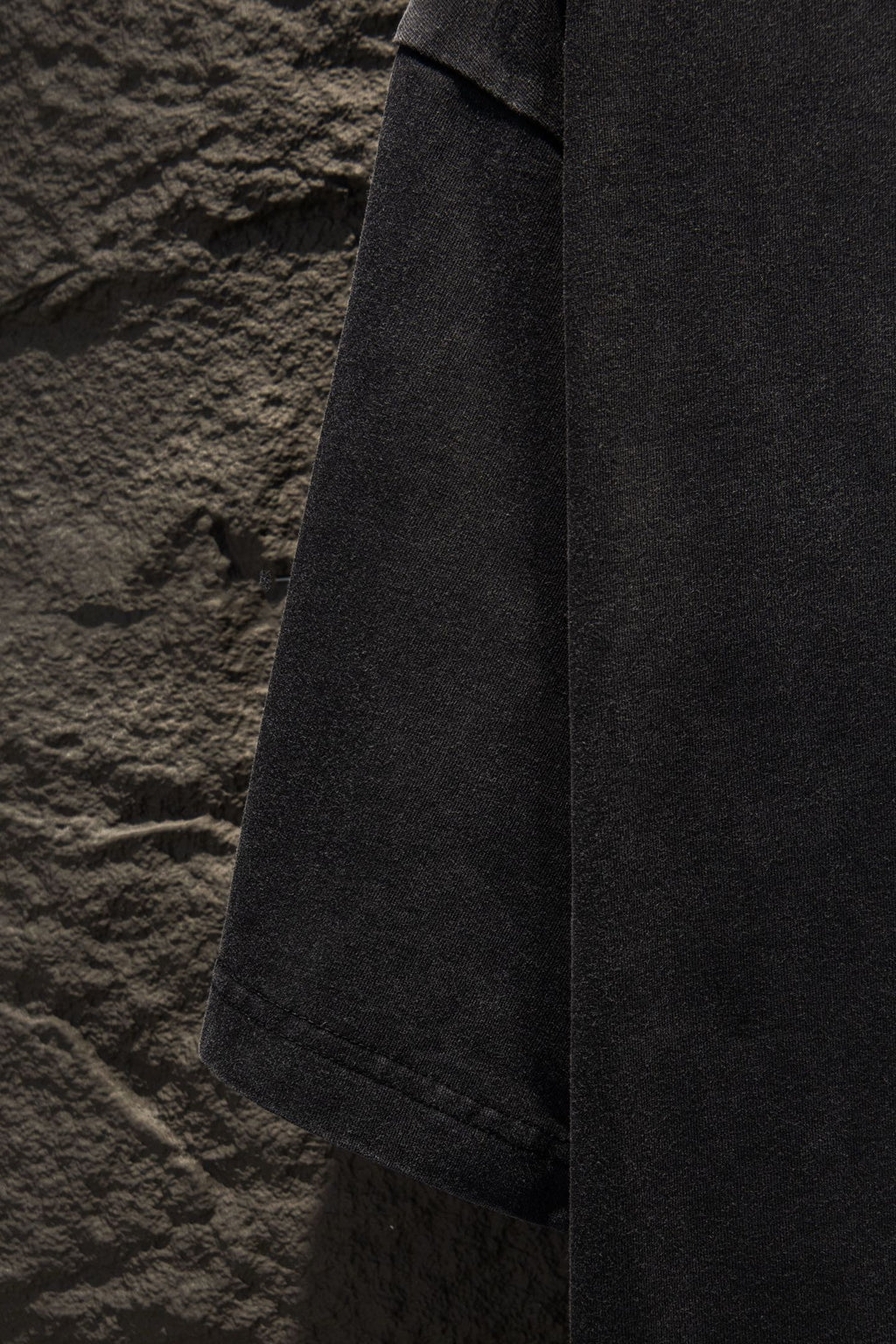 Balenciaga T-shirt side view, dark gray hem and stitched seam