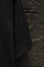 Balenciaga T-shirt sleeve edge close-up, dark gray fabric with seam