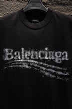 Black T-shirt chest logo detail with distressed Balenciaga lettering