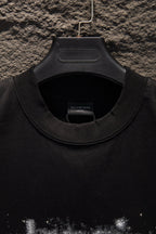 Black T-shirt neckline with ribbed crew collar and inner neck label