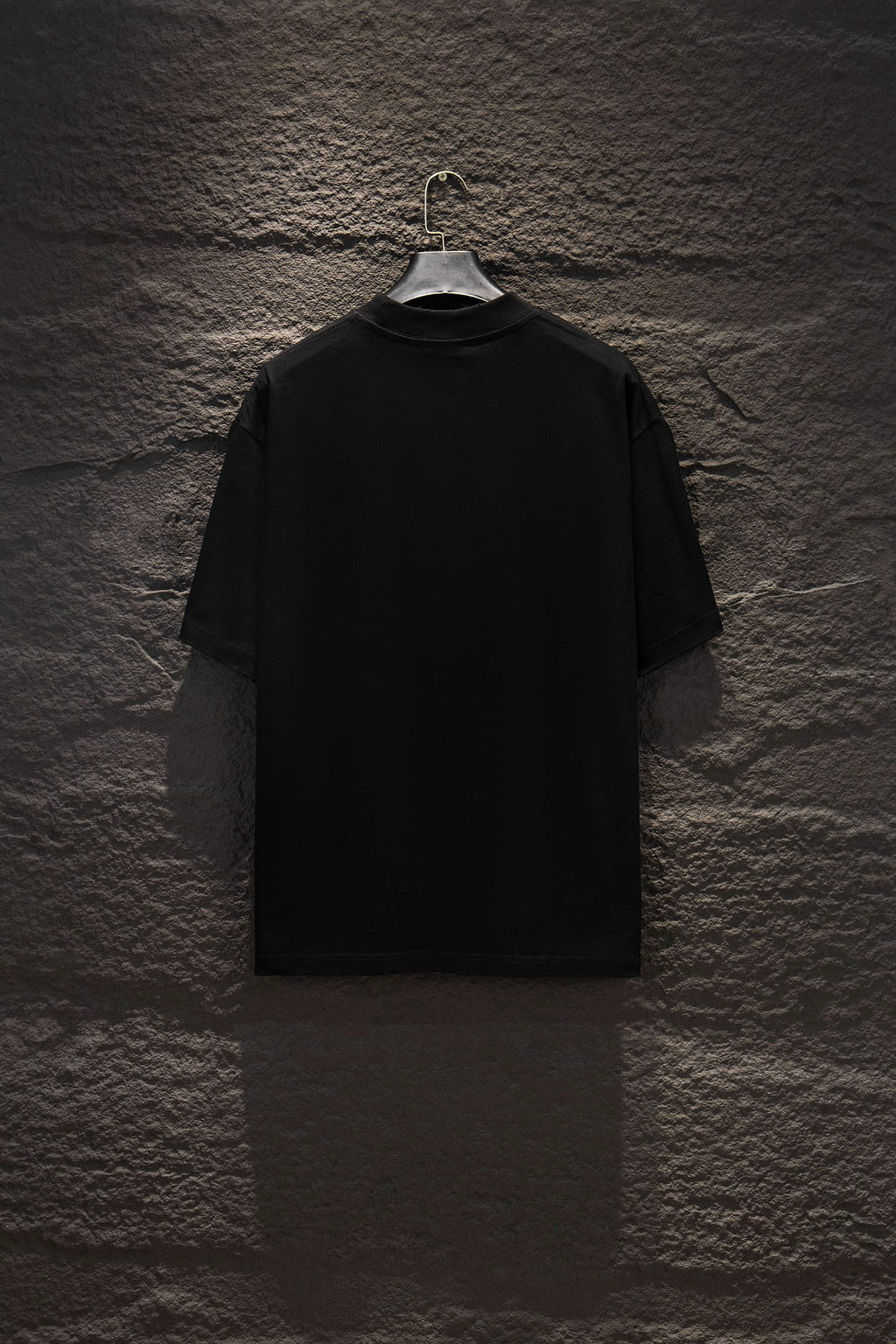 Black crewneck T-shirt with short sleeves, plain back view on a hanger