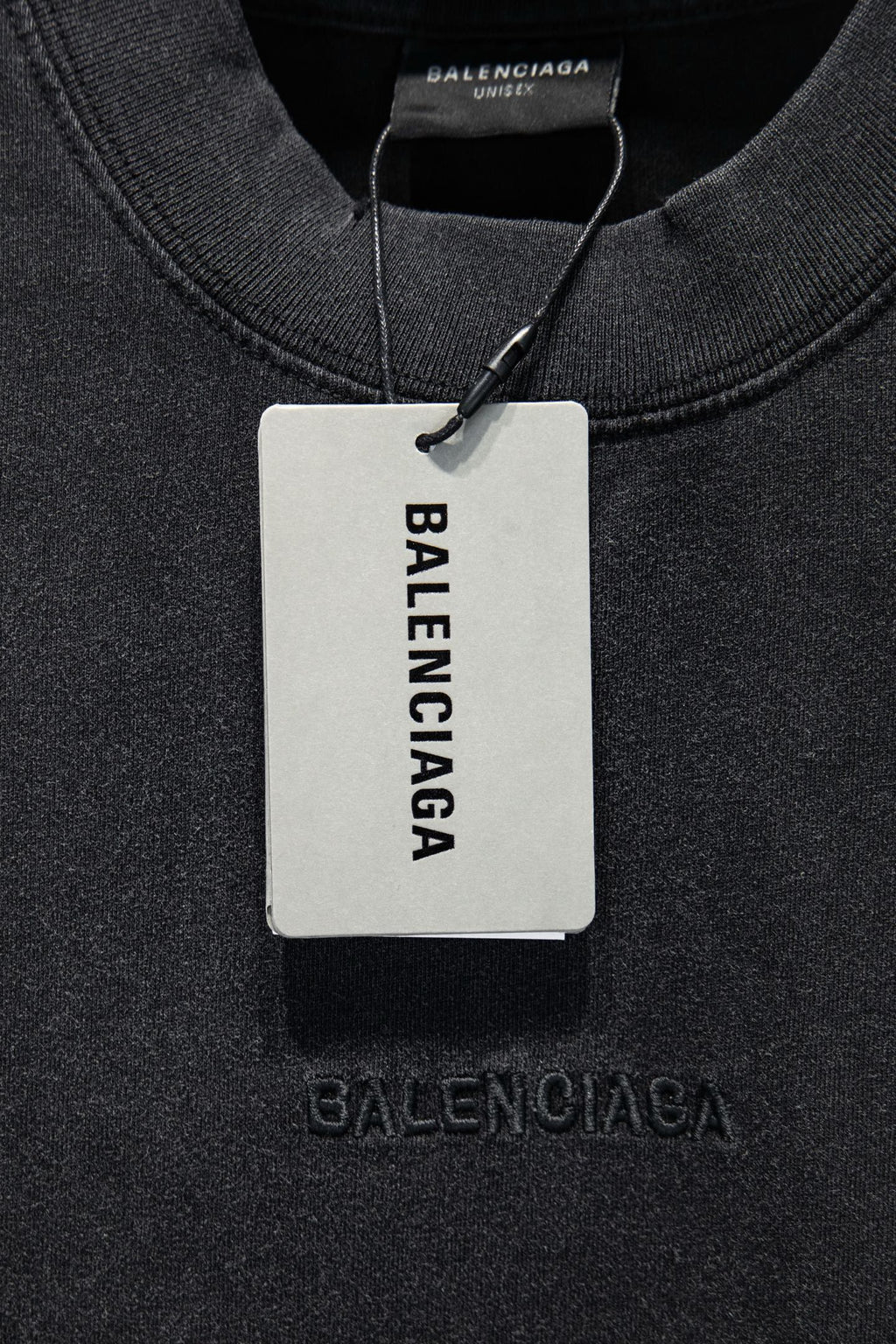 Balenciaga T-shirt collar with hanging tag reading BALENCIAGA, dark gray