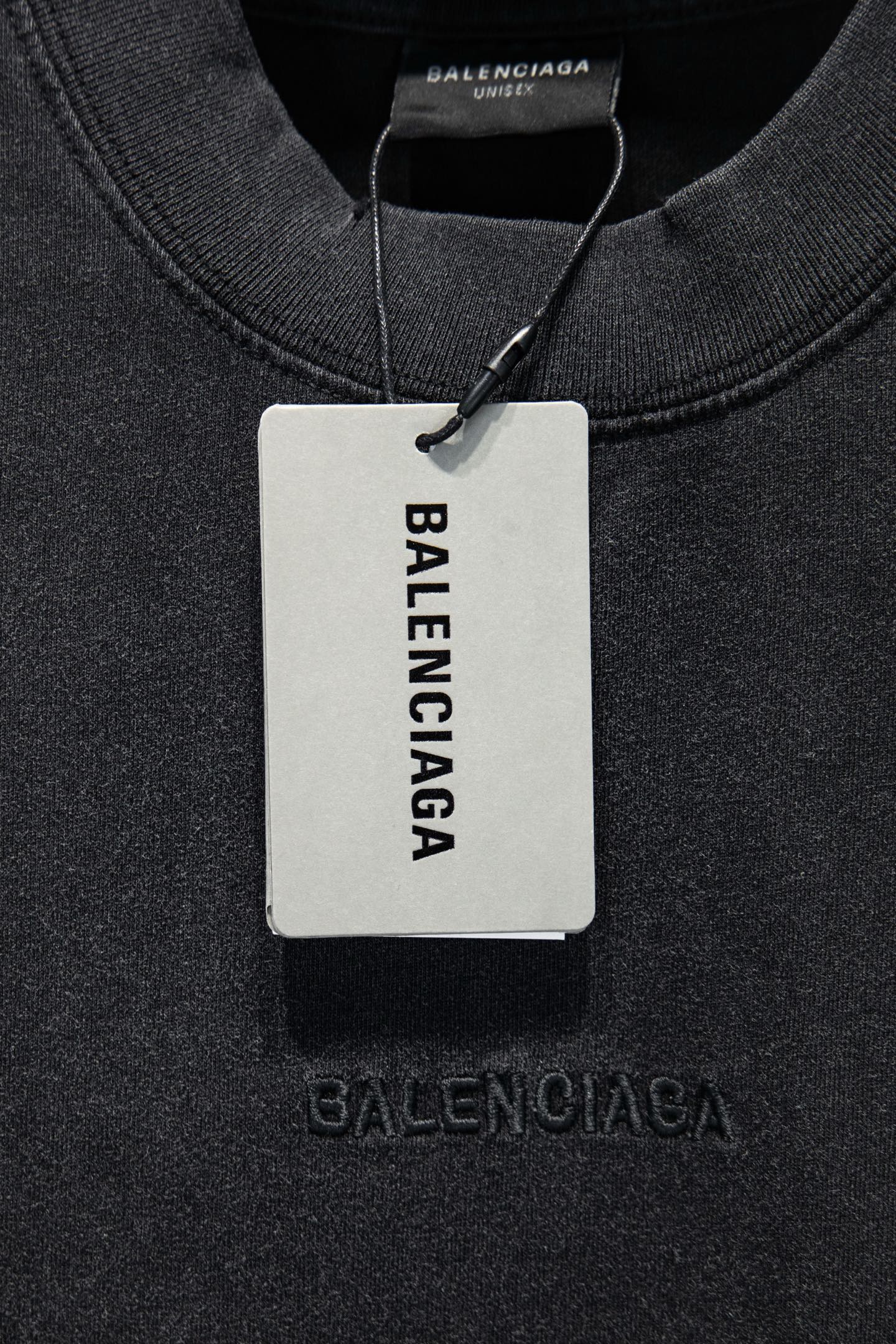 Balenciaga T-shirt collar with hanging tag reading BALENCIAGA, dark gray