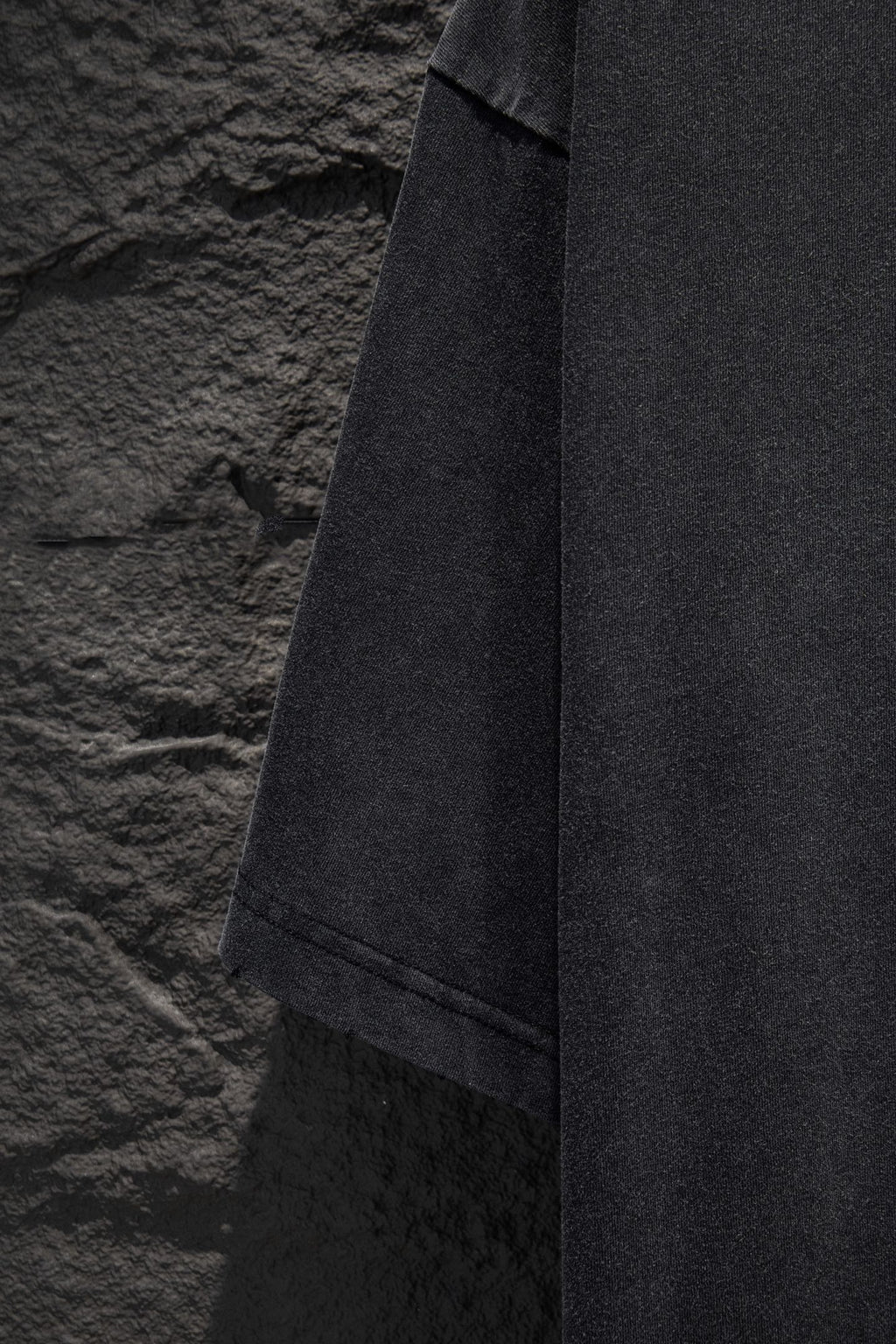 Balenciaga T-shirt hem and side seam view, dark gray fabric