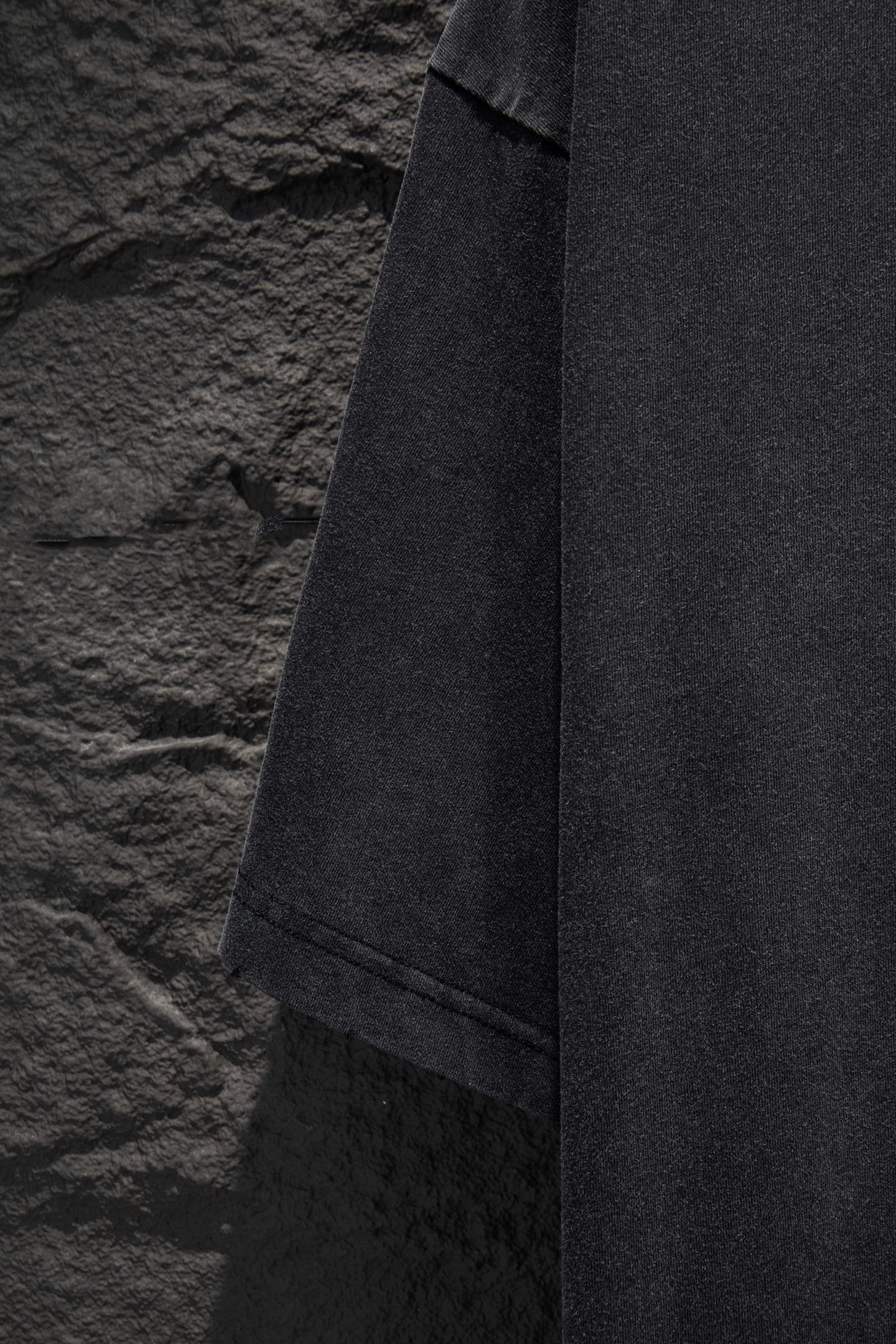 Balenciaga T-shirt hem and side seam view, dark gray fabric