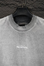 Balenciaga T-shirt neckline with ribbed crew collar and small chest logo embroidery.