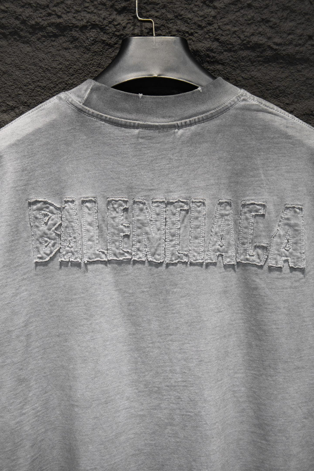 Balenciaga T-shirt with large distressed back text across upper yoke.