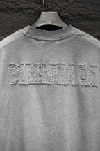 Balenciaga T-shirt with large distressed back text across upper yoke.