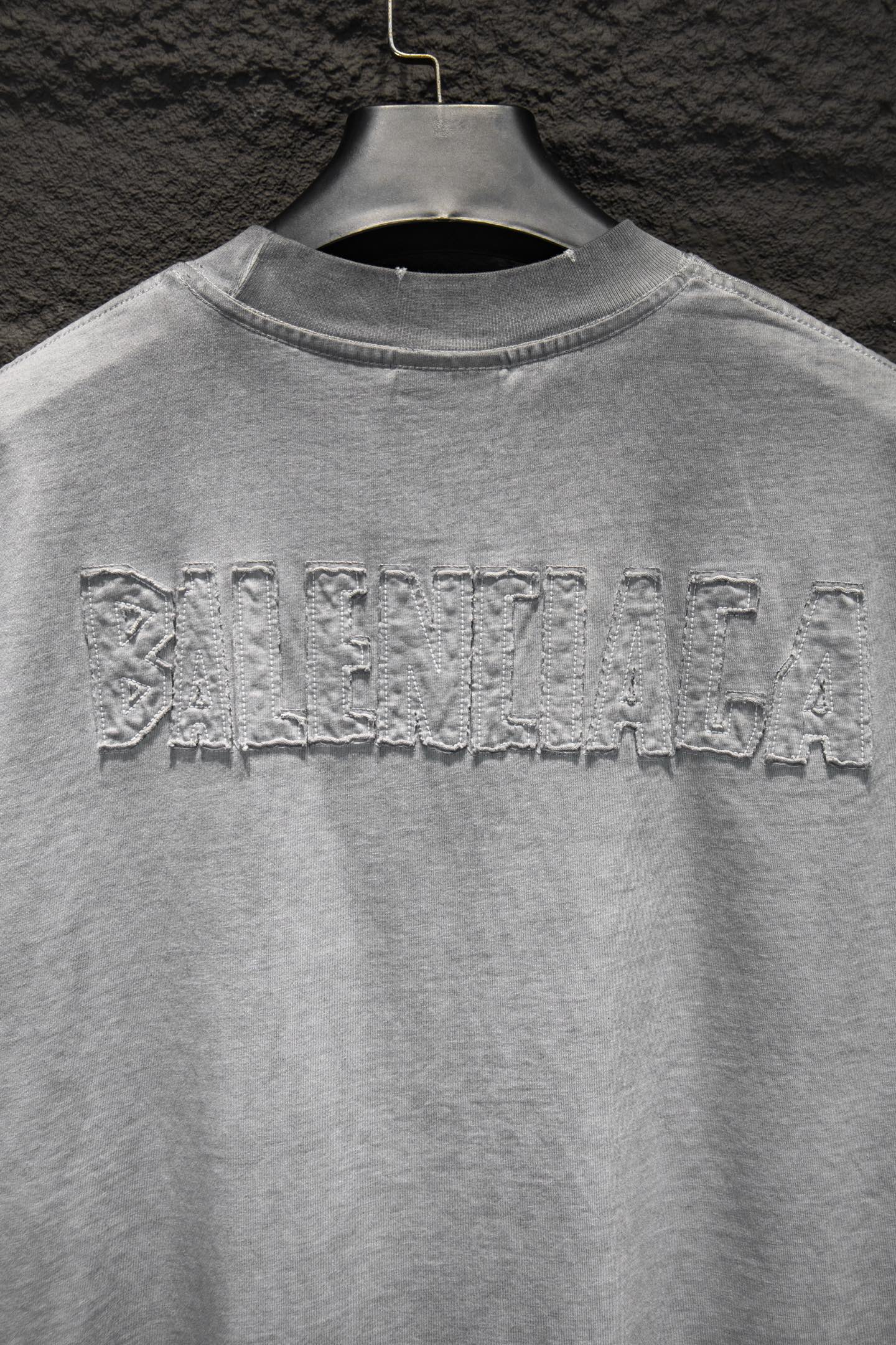 Balenciaga T-shirt with large distressed back text across upper yoke.
