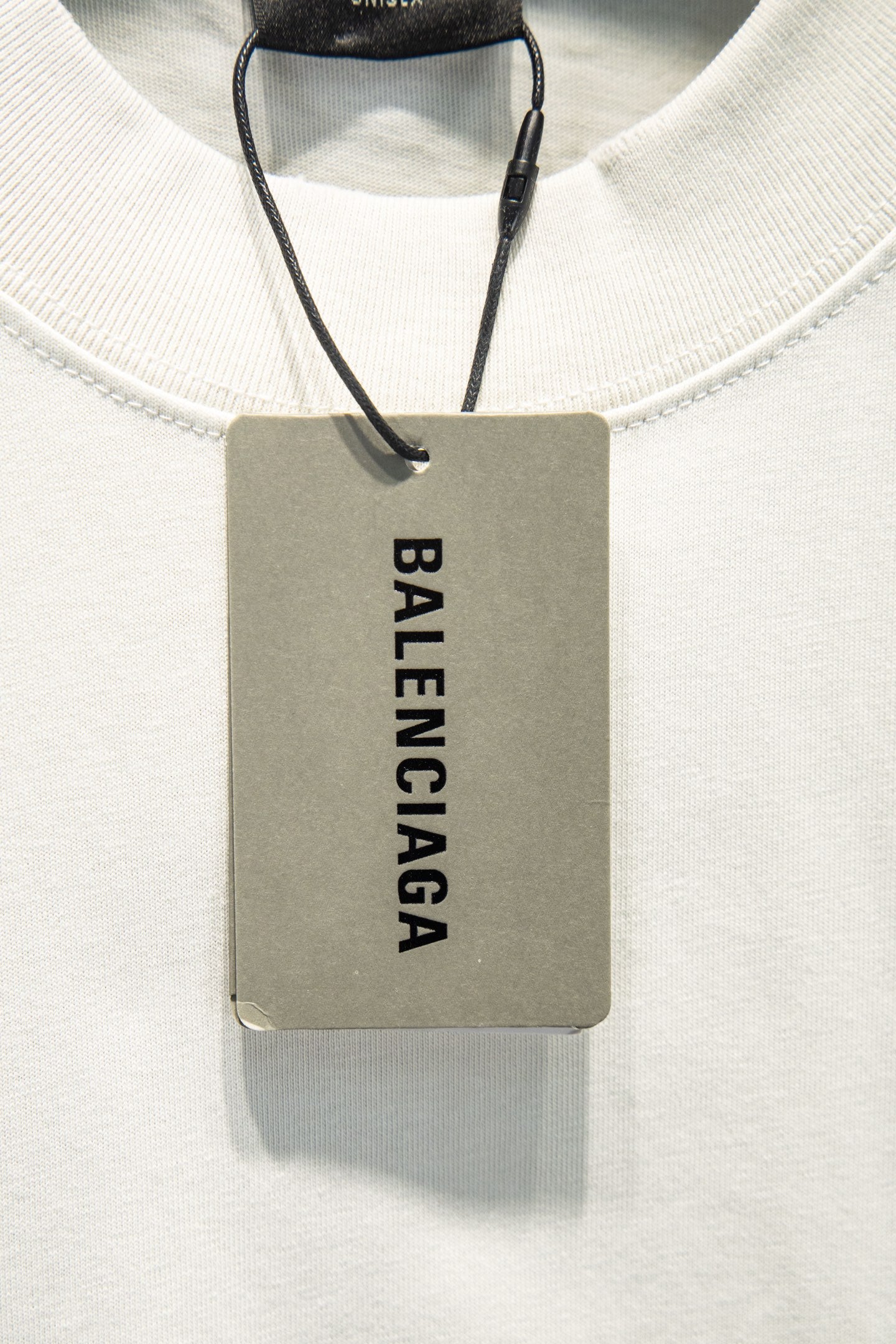 Balenciaga white crewneck T-shirt with hanging brand tag at neckline