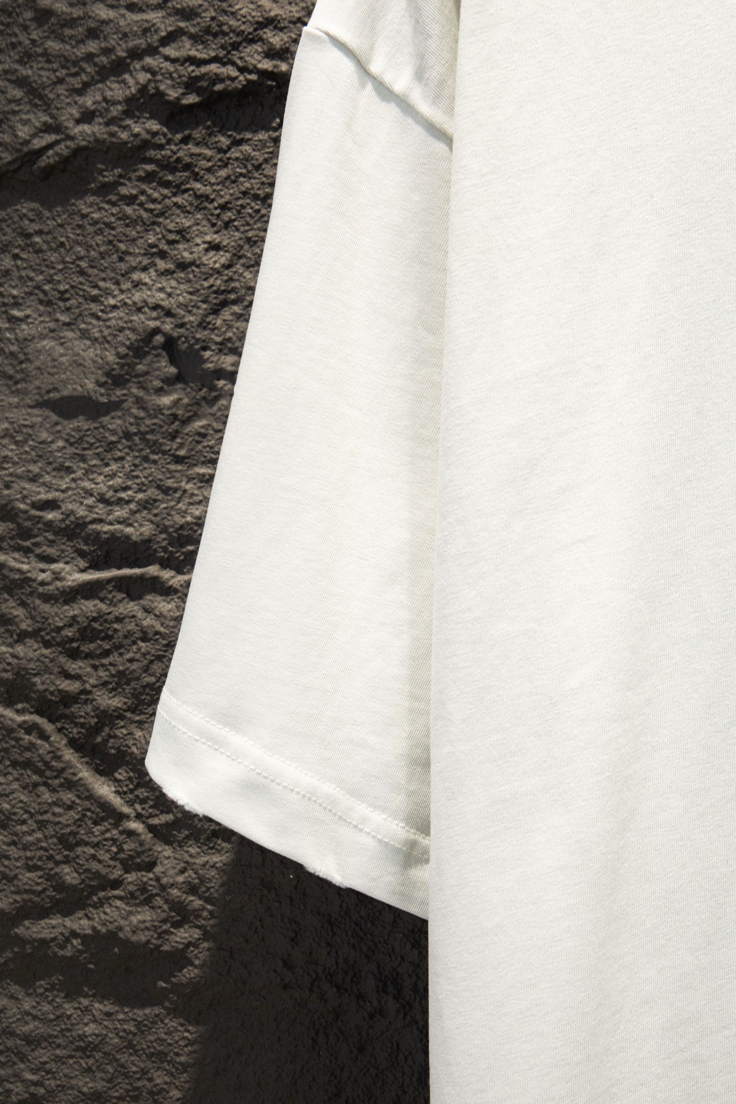 Balenciaga white short-sleeve T-shirt side view with curved hem