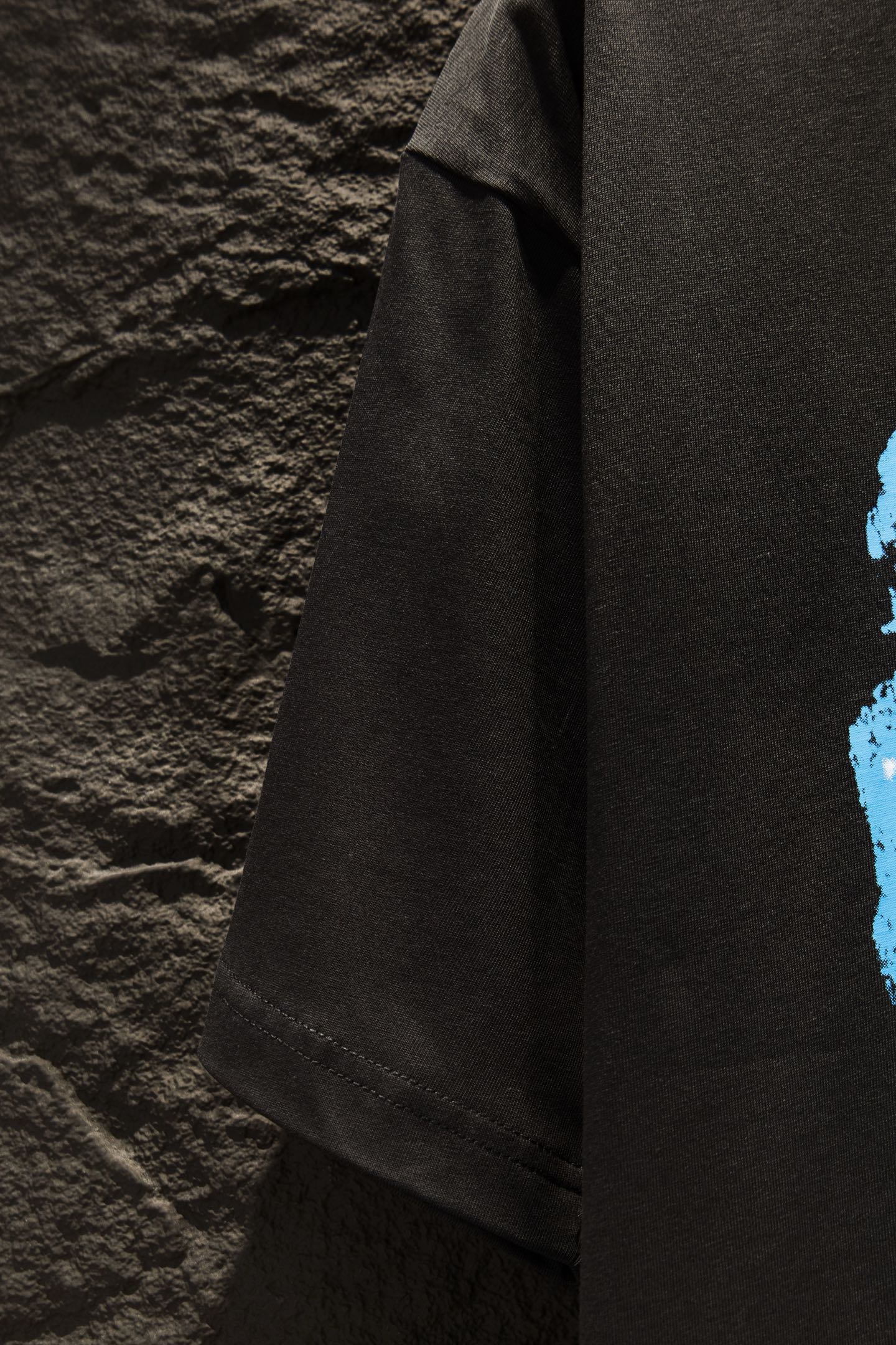 Balenciaga black T-shirt angled side view, visible sleeve seam