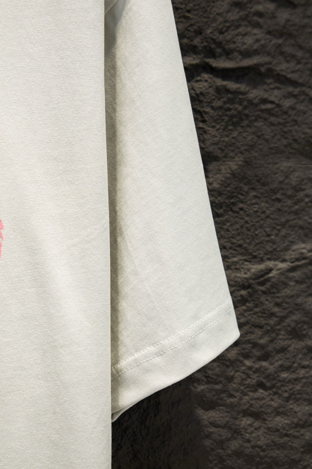 White short-sleeve T-shirt showing the side hem and sleeve seam