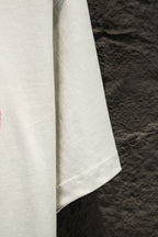 White short-sleeve T-shirt showing the side hem and sleeve seam