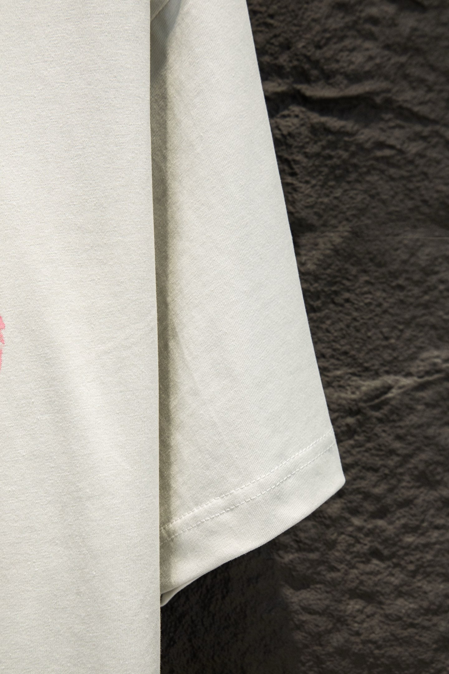 White short-sleeve T-shirt showing the side hem and sleeve seam