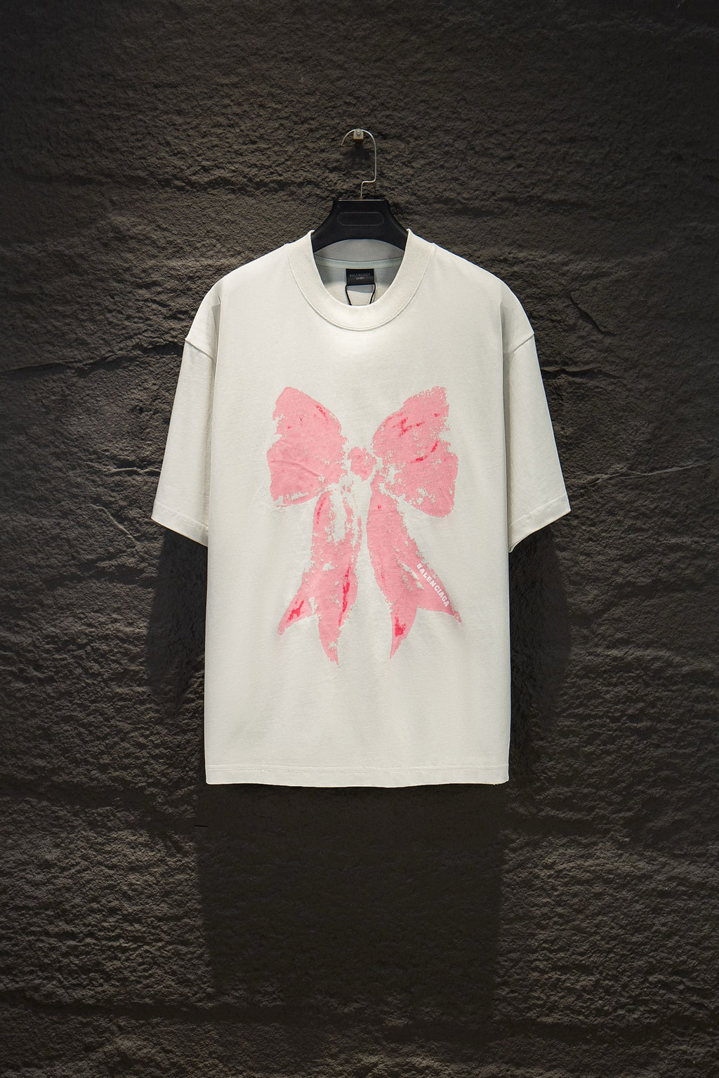 White short-sleeve T-shirt with pink bow graphic print on the front