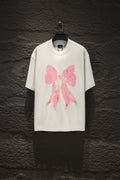 White short-sleeve T-shirt with pink bow graphic print on the front