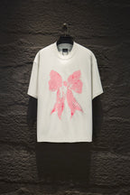 White short-sleeve T-shirt with pink bow graphic print on the front