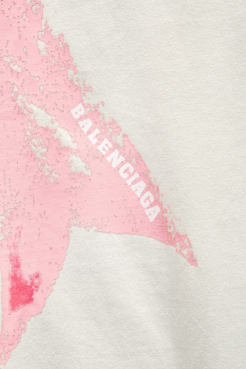 White T-shirt detail showing pink bow graphic with partial “BALENCIAGA” text