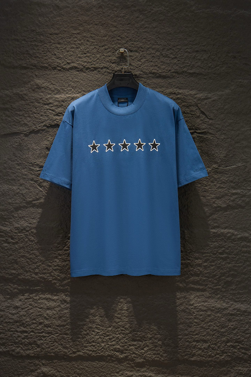 Blue short-sleeve T-shirt with five star graphics across the chest