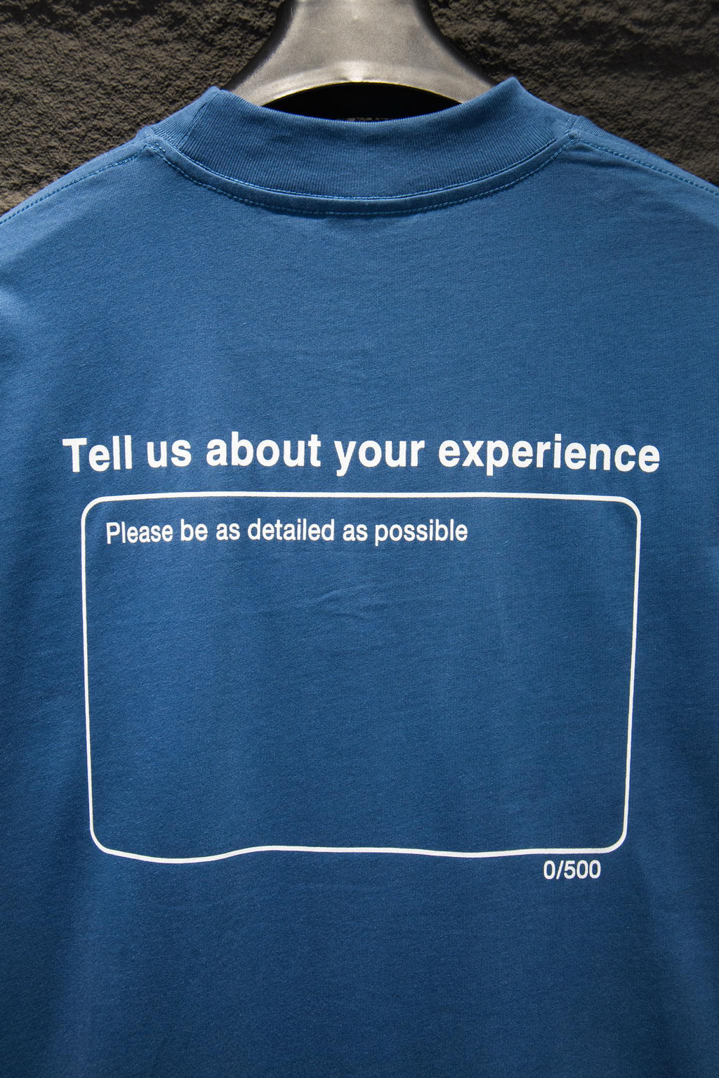 Blue short-sleeve T-shirt with back text and bordered message box