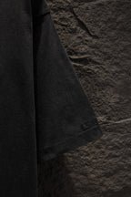 Black T-shirt sleeve with small “BALENCIAGA” embroidery near the hem