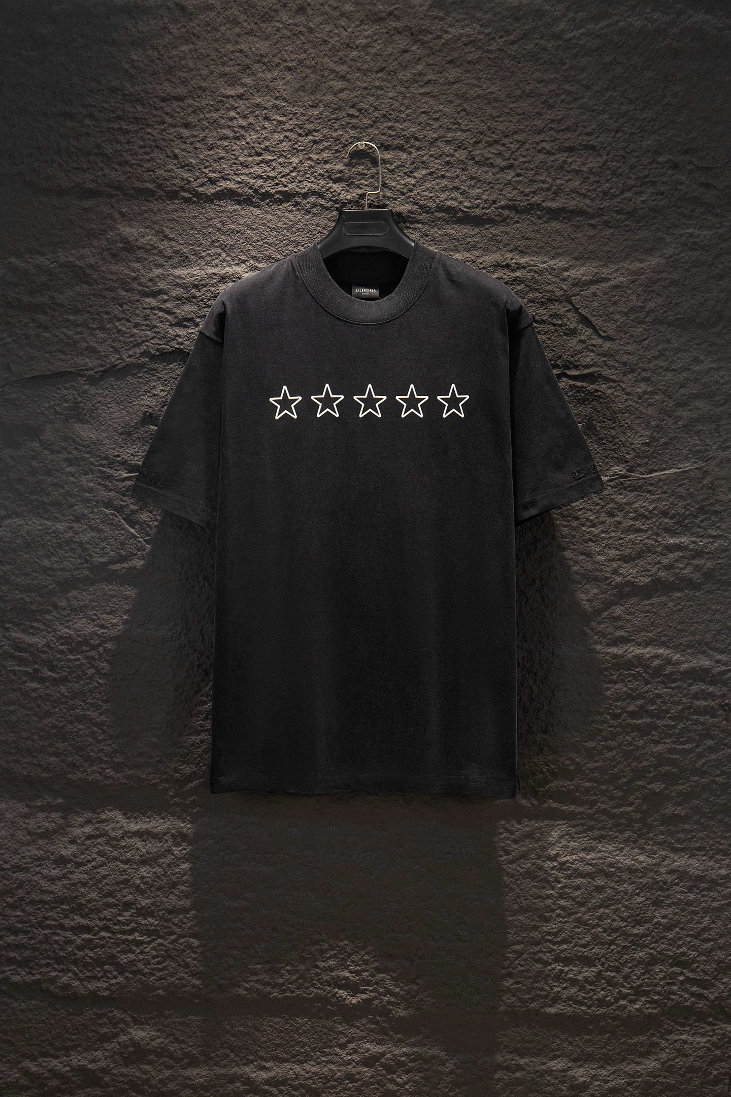 Black short-sleeve T-shirt with five white star prints on the chest