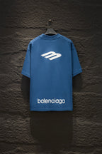 Blue short-sleeve T-shirt with large white logo and 'balenciaga' text