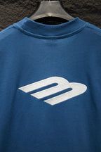 Blue T-shirt with large white logo print on the chest