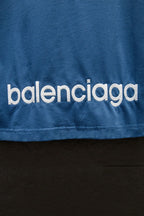 Blue T-shirt with 'balenciaga' logo text near the hem